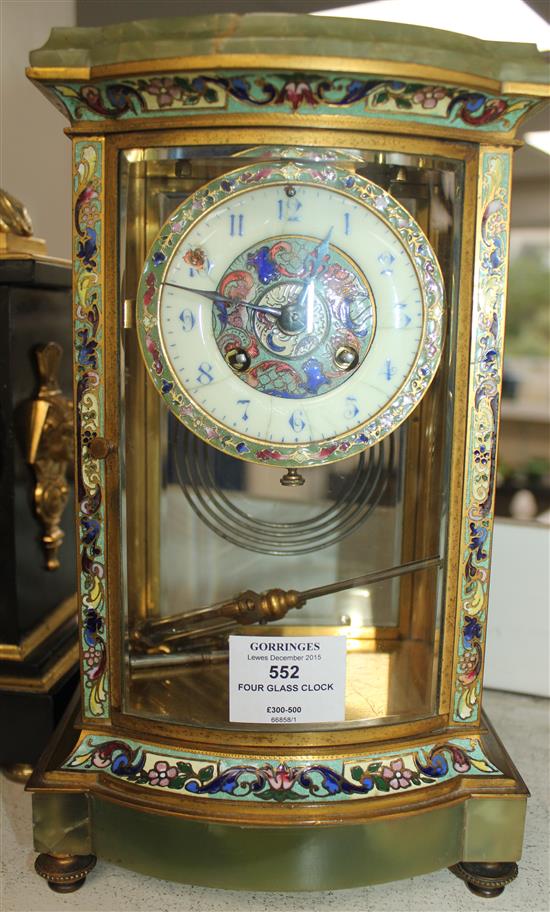 An early 20th century French champlevé enamelled ormolu and green onyx four glass mantel clock, 12in.